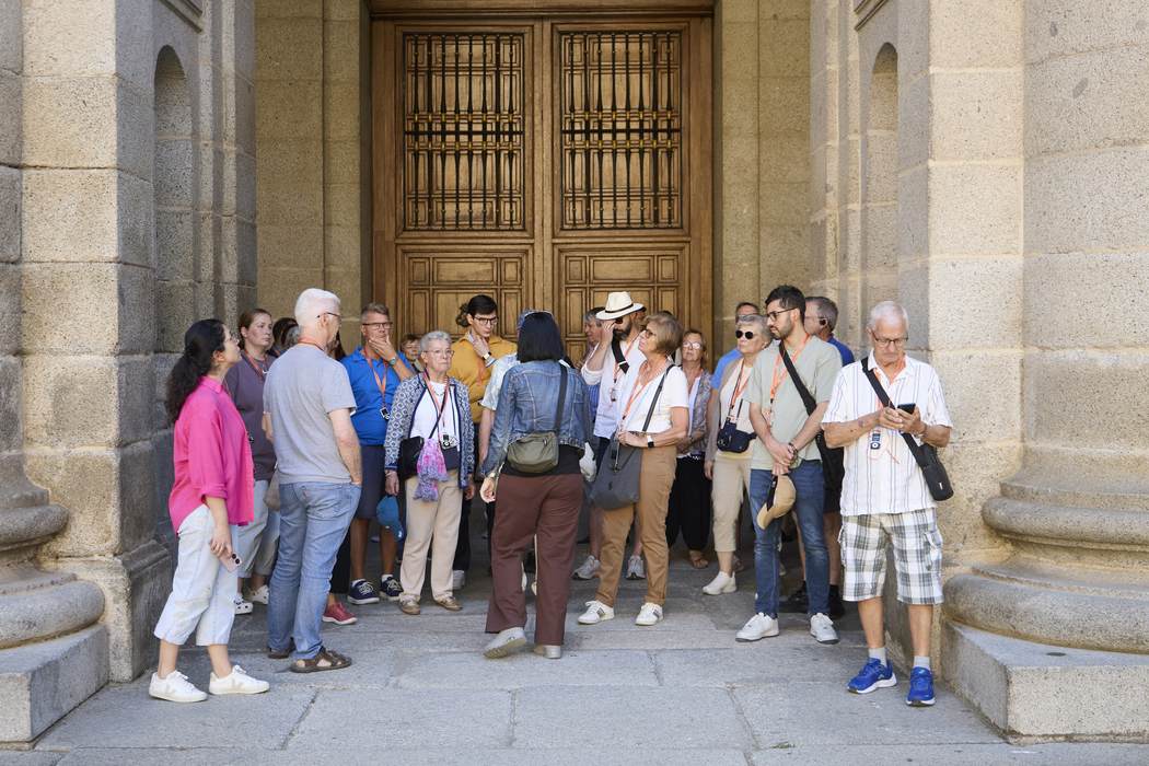 Guided group entering the monastery doorway at El Escorial