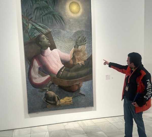 Guide explaining a surrealist painting by Salvador Dalí at the Reina Sofía Museum