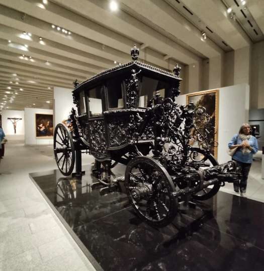 Black state carriage on display at the Royal Collections Gallery in Madrid