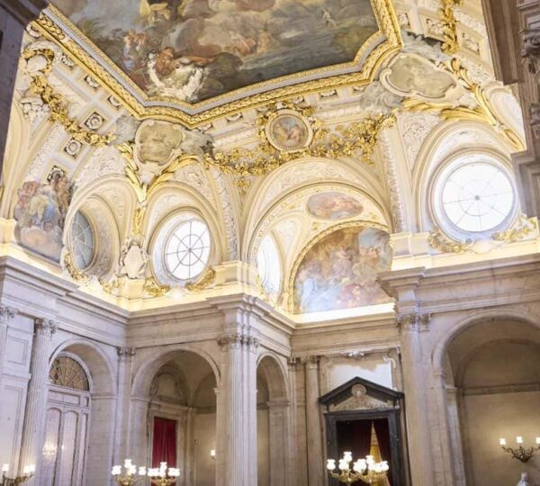 Ornate hall with antique clock inside the Royal Palace of Madrid